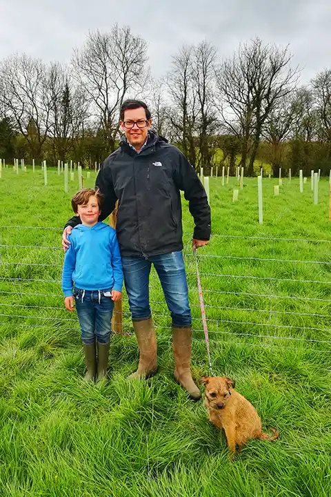 Ben, son Ethan and Freddie the dog in the field