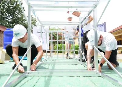 Volunteers building a water tower